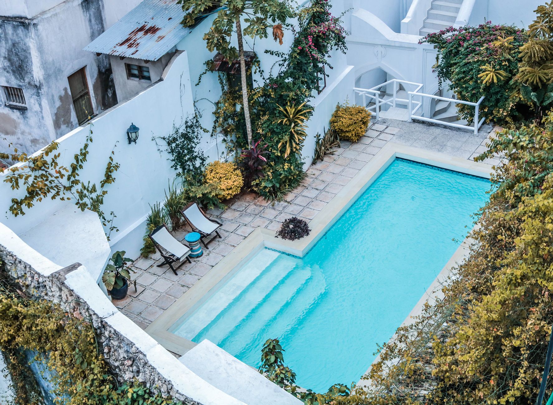 Aerial view of courtyard inground pool with landscaping